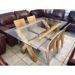 Lovely solid wood and glass dining table and 4 chairs.