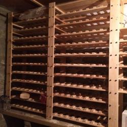 Wine racks IKEA. Wooden. Can be assembled to fit most spaces. Great quality. Looks good in the house