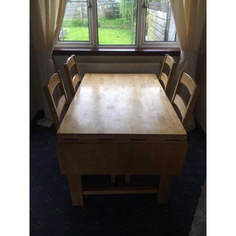 Large wooden table and chairs with folding leafs