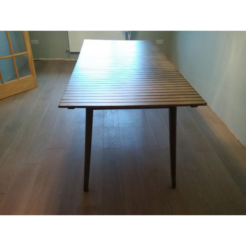 Green slatted dining table